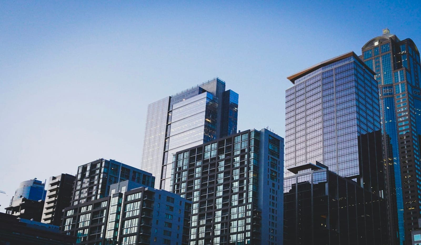 Cluster of residential and commercial towers against a blue sky